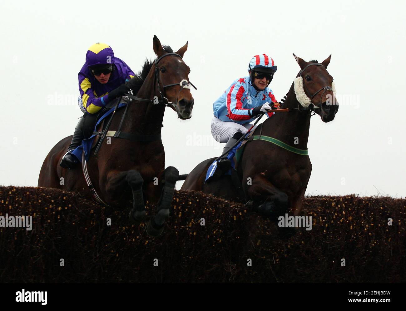 Horse Racing - Wincanton  - Wincanton Racecourse - 14/10/10  Outside Investor ridden by Keiran Burke (R) clears a fence with Keltic Lord ridden by Nick Schofield before going on to win the 15.50 The Higos Insurance Services Somerton Handicap Steeple Chase  Mandatory Credit: Action Images / Julian Herbert  Livepic Stock Photo