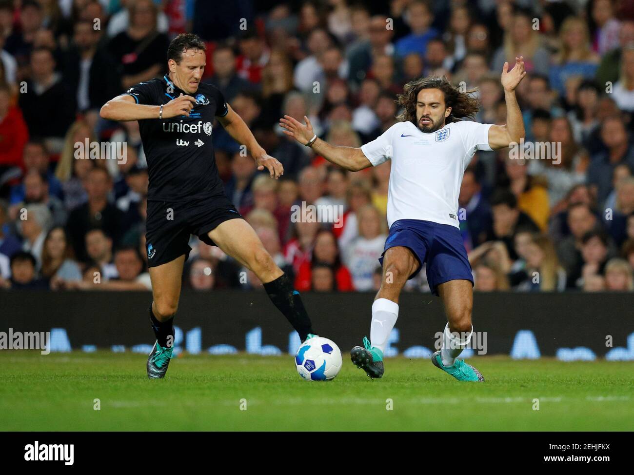 Soccer Football - Soccer Aid 2018 - England v Soccer Aid World XI - Old Trafford, Manchester, Britain - June 10, 2018   World XI's Brendan Cole in action with England's Joe Wicks   REUTERS/Phil Noble Stock Photo