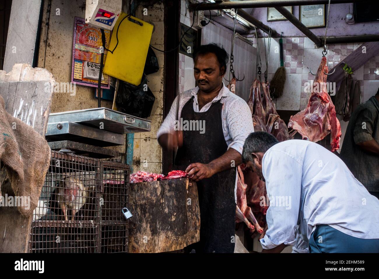 Indian butcher in Chennai at working chopping meats in open Stock Photo Alamy