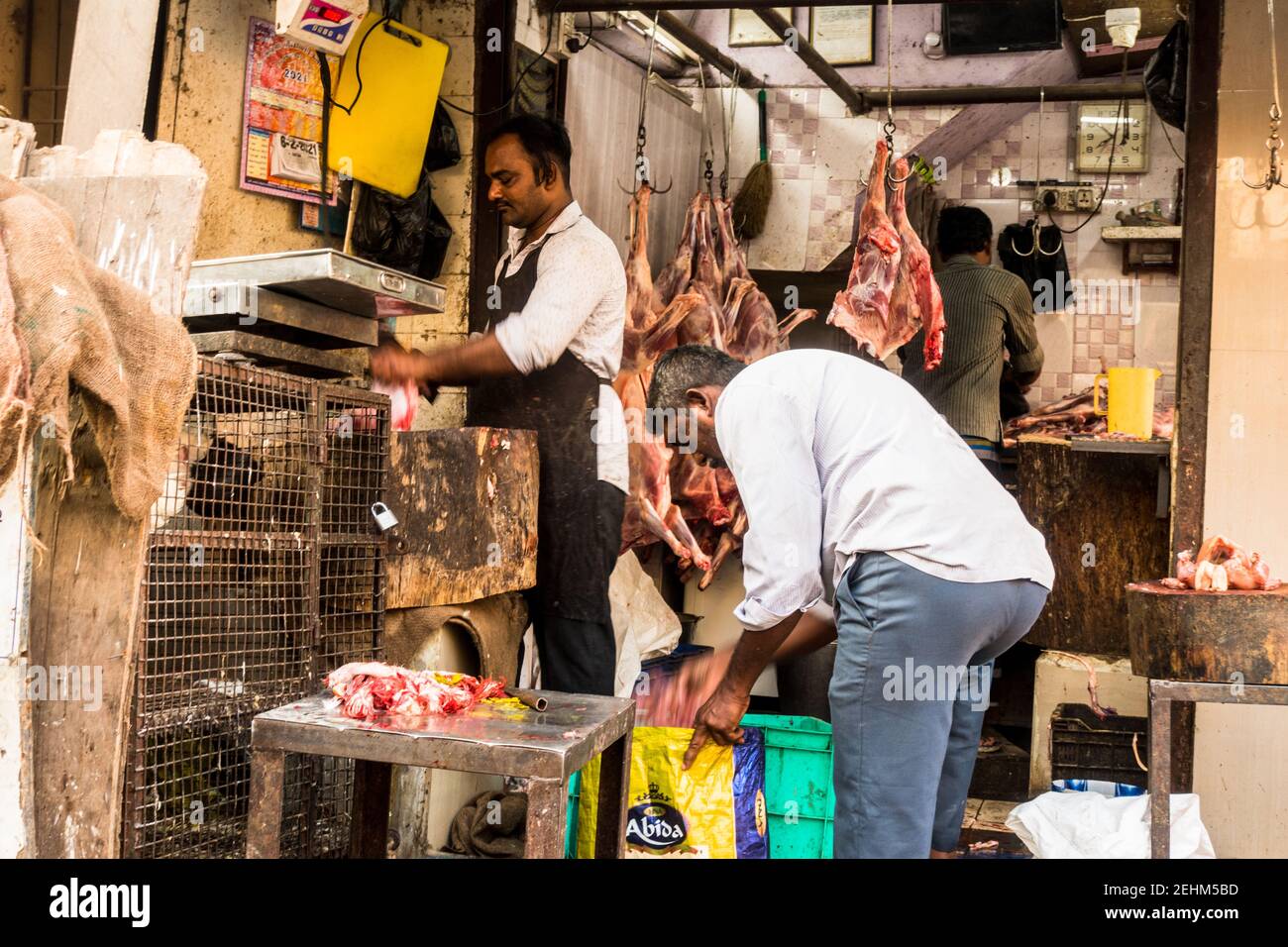 Butcher in India curring meat in open air Stock Photo