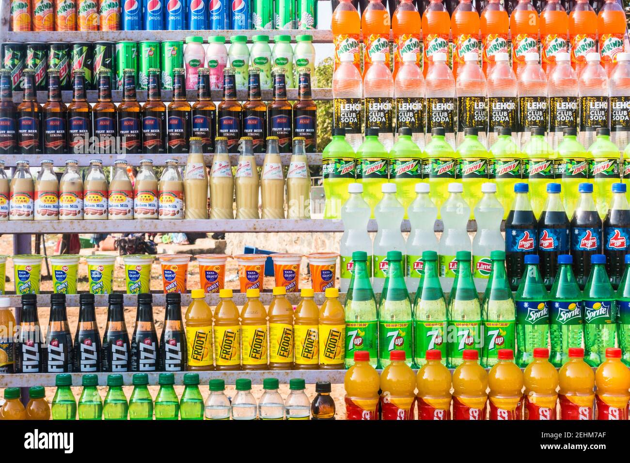 Various brand soda, fizzy drinks and fruit juices stacked up in open