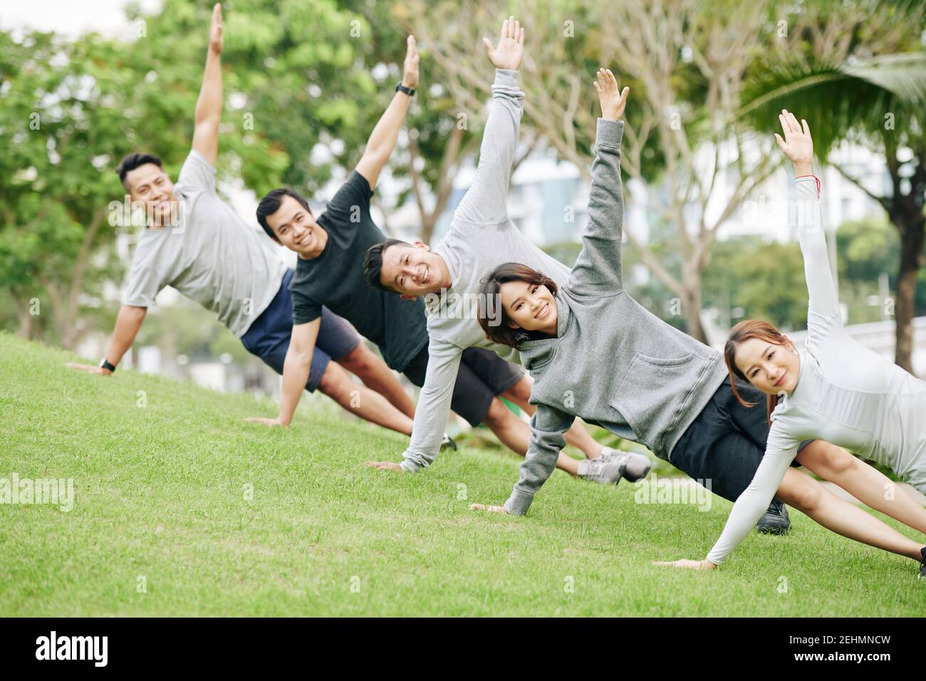 Young people doing side plank Stock Photo
