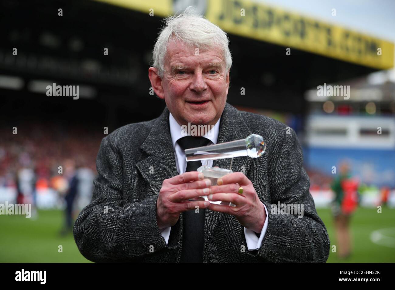 Soccer Football - Premier League - Crystal Palace vs West Bromwich Albion - Selhurst Park, London, Britain - May 13, 2018 Commentator John Motson holds up an award he was presented after the match REUTERS/Hannah McKay EDITORIAL USE ONLY. No use with unauthorized audio, video, data, fixture lists, club/league logos or "live" services. Online in-match use limited to 75 images, no video emulation. No use in betting, games or single club/league/player publications. Please contact your account representative for further details. Stock Photo