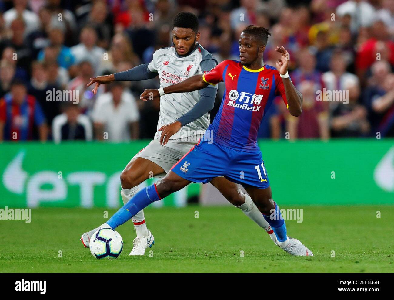 Soccer Football - Premier League - Crystal Palace v Liverpool - Selhurst Park, London, Britain - August 20, 2018  Crystal Palace's Wilfried Zaha in action with Liverpool's Joe Gomez                     REUTERS/Eddie Keogh  EDITORIAL USE ONLY. No use with unauthorized audio, video, data, fixture lists, club/league logos or 'live' services. Online in-match use limited to 75 images, no video emulation. No use in betting, games or single club/league/player publications.  Please contact your account representative for further details. Stock Photo