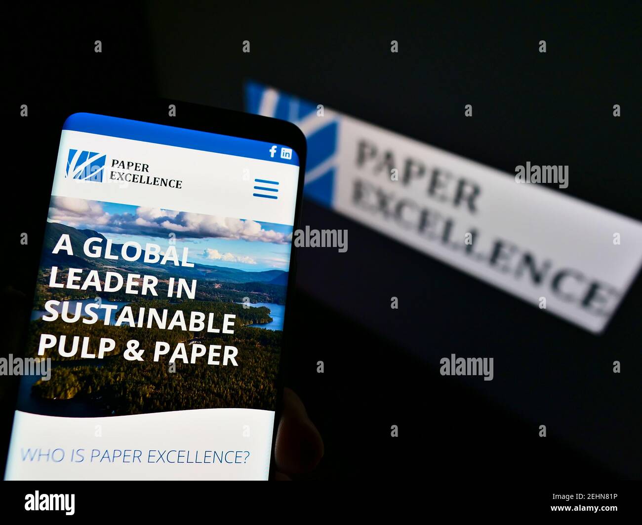 Cellphone with web page of Canadian paper and pulp manufacturer Paper Excellence B.V. on screen in front of logo. Focus on center of phone display. Stock Photo