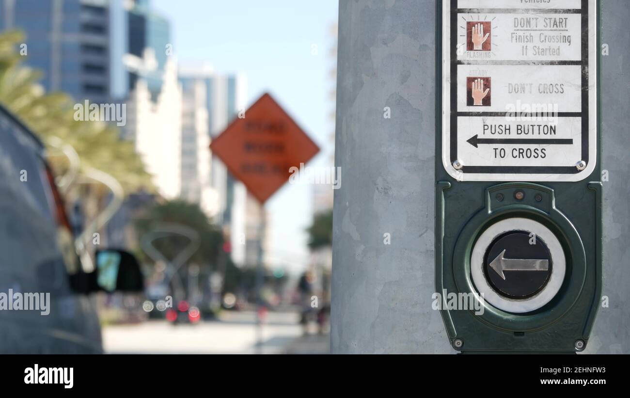 Traffic light button on pedestrian crosswalk, people have to push and