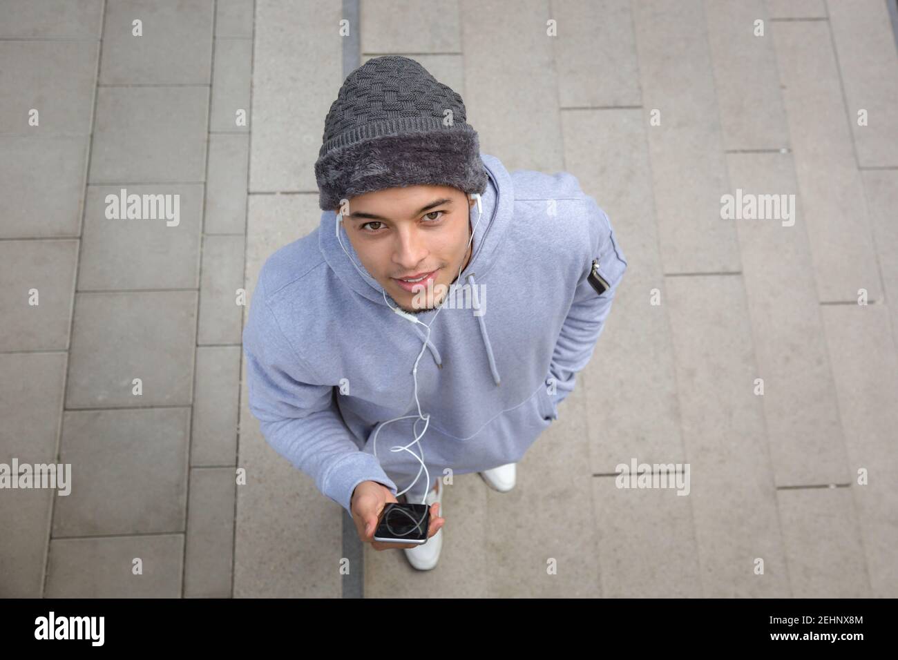 Listening to music young latin man runner sports training from above top view outdoor Stock Photo