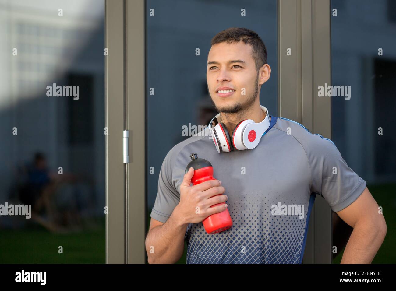 Young man looking up into the future runner outdoor sports fitness training outside Stock Photo