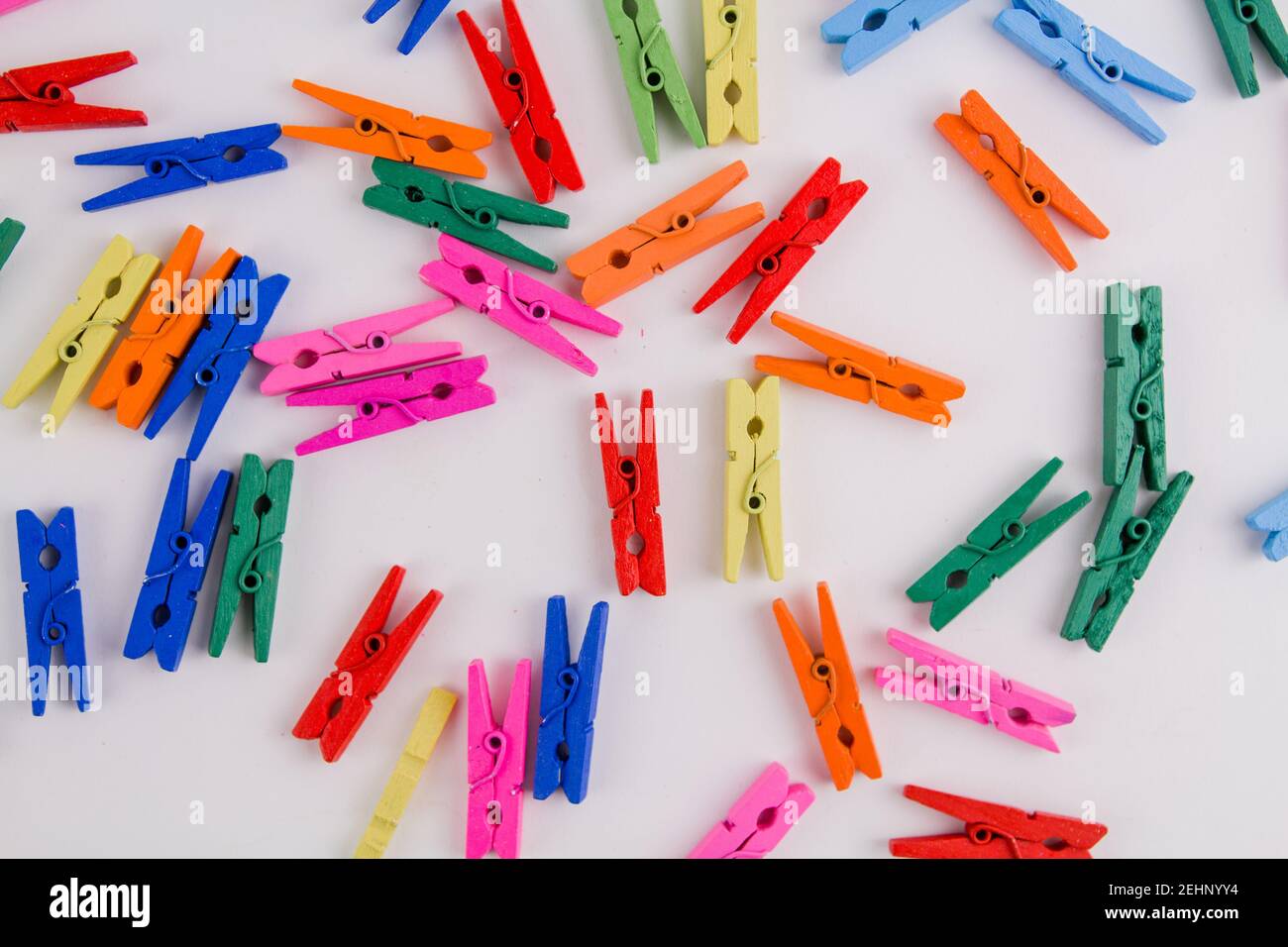 a multicolored clothespins on a white background Stock Photo