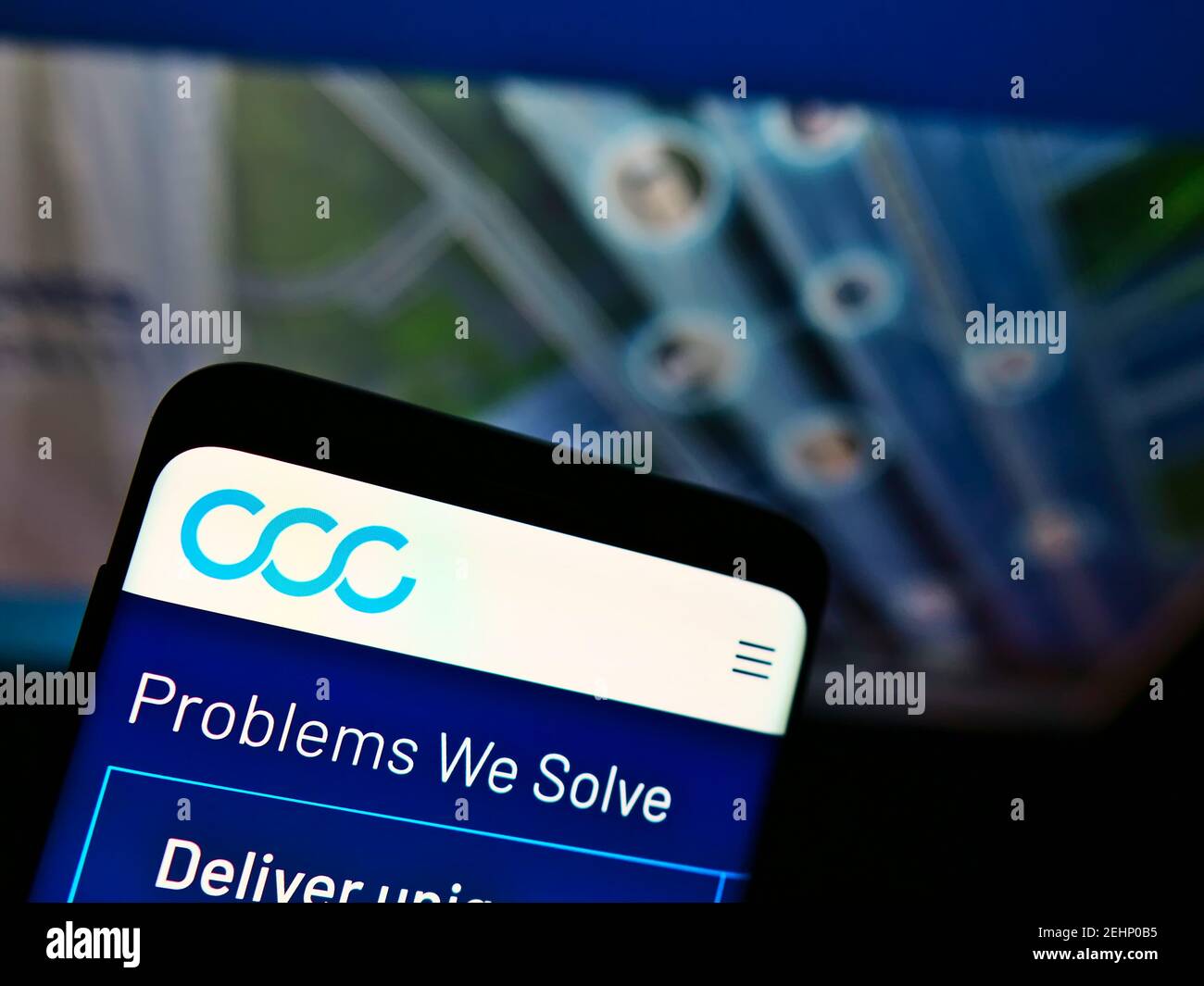 Smartphone with business website and logo of American software company CCC Information Services Inc. on screen. Focus on top-left of phone display. Stock Photo