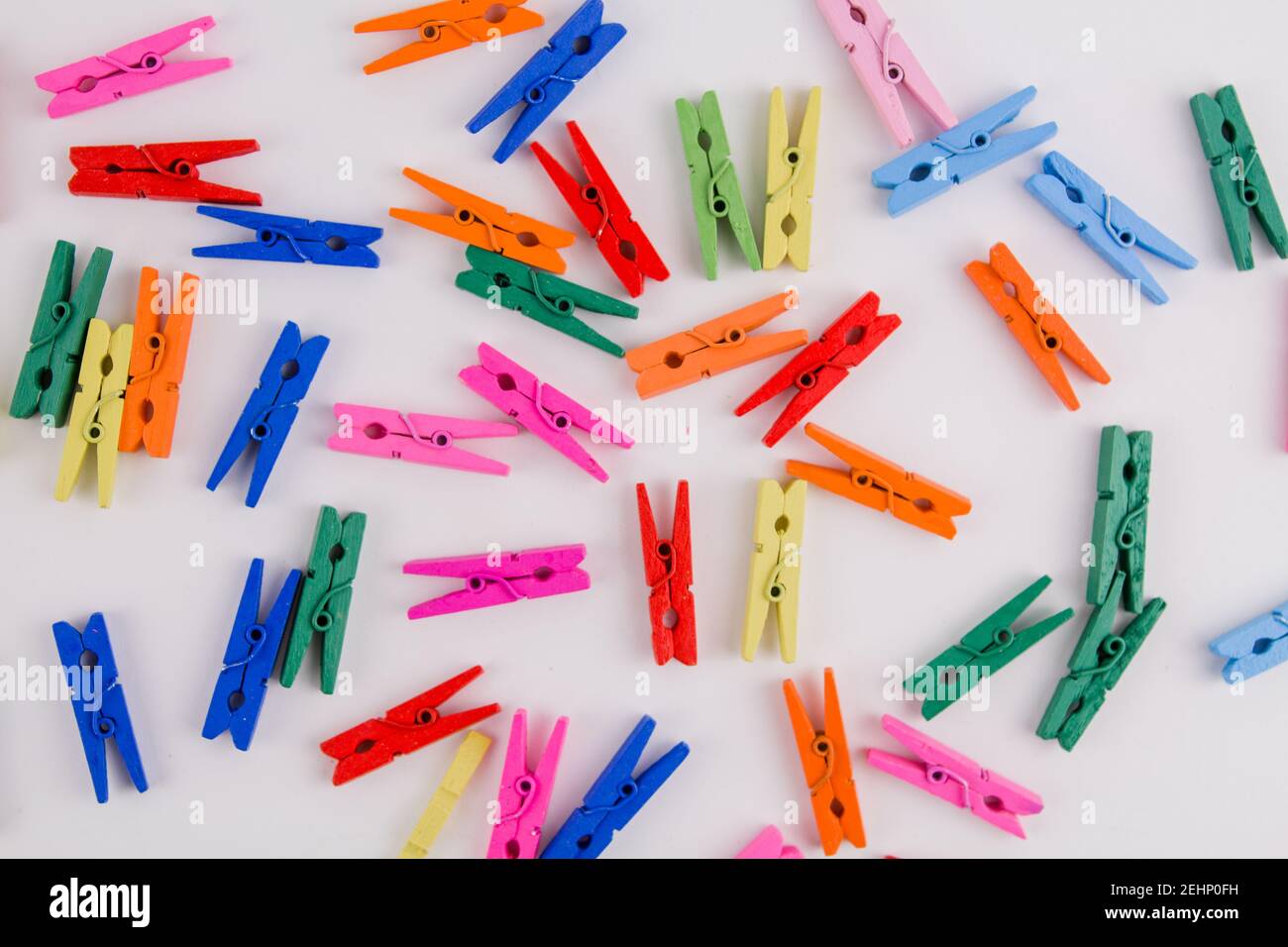a multicolored clothespins on a white background Stock Photo