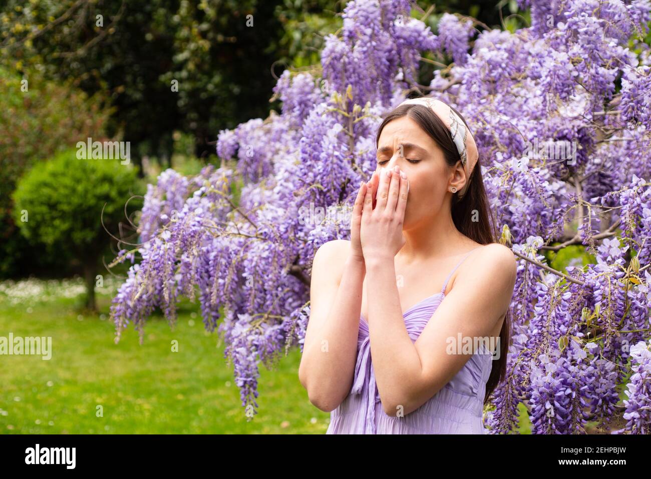 Girl sneezing with allergy symptom concept. Woman being allergic to