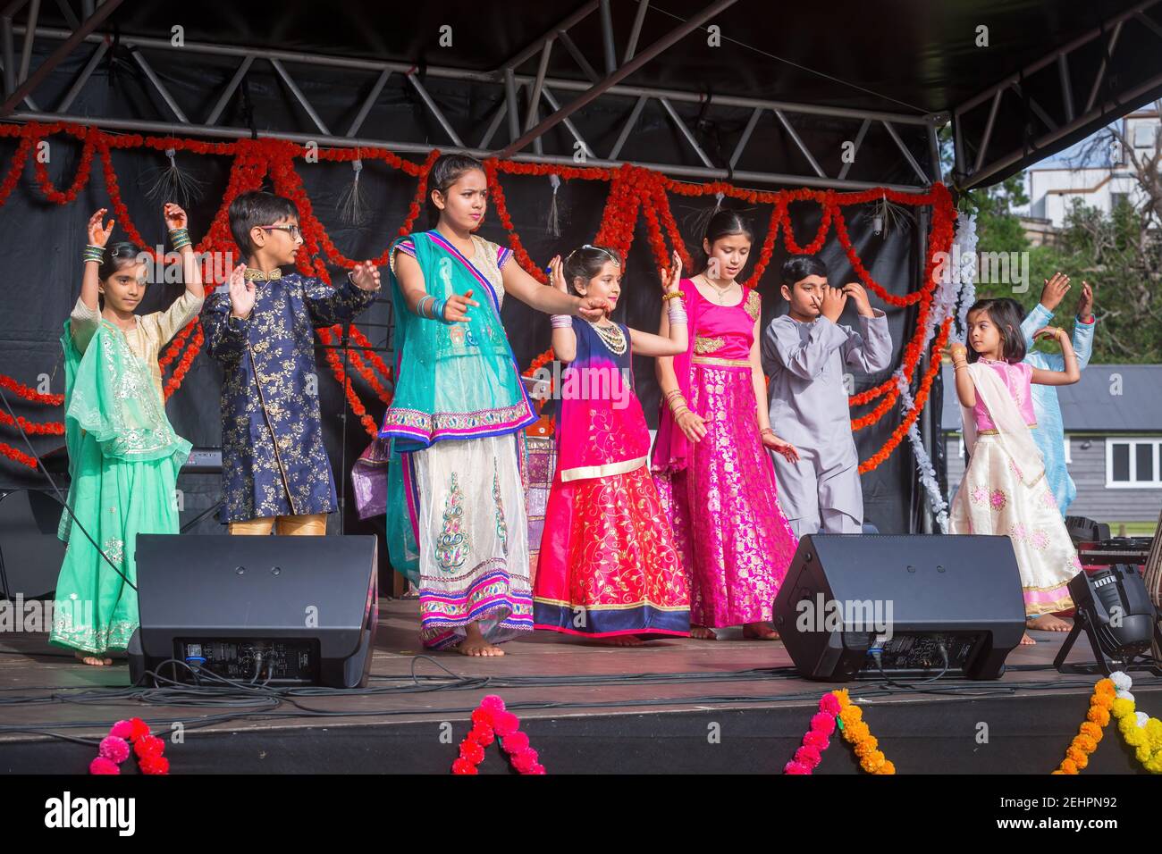 A group of children in traditional Indian clothing on stage during Diwali festival celebrations in Tauranga, New Zealand Stock Photo