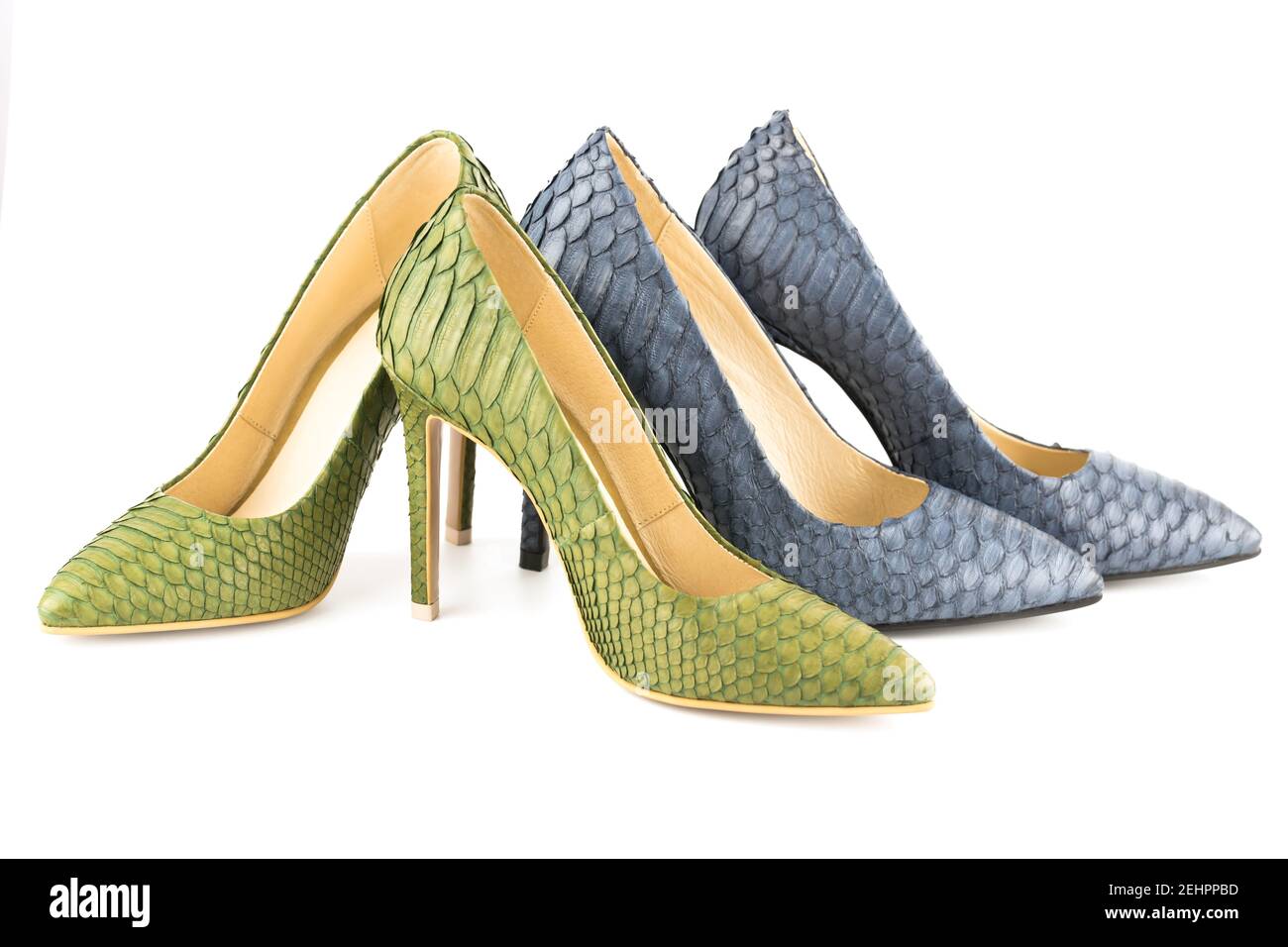 Two pairs of stylish high heels python leather shoes isolated on white background. Stock Photo