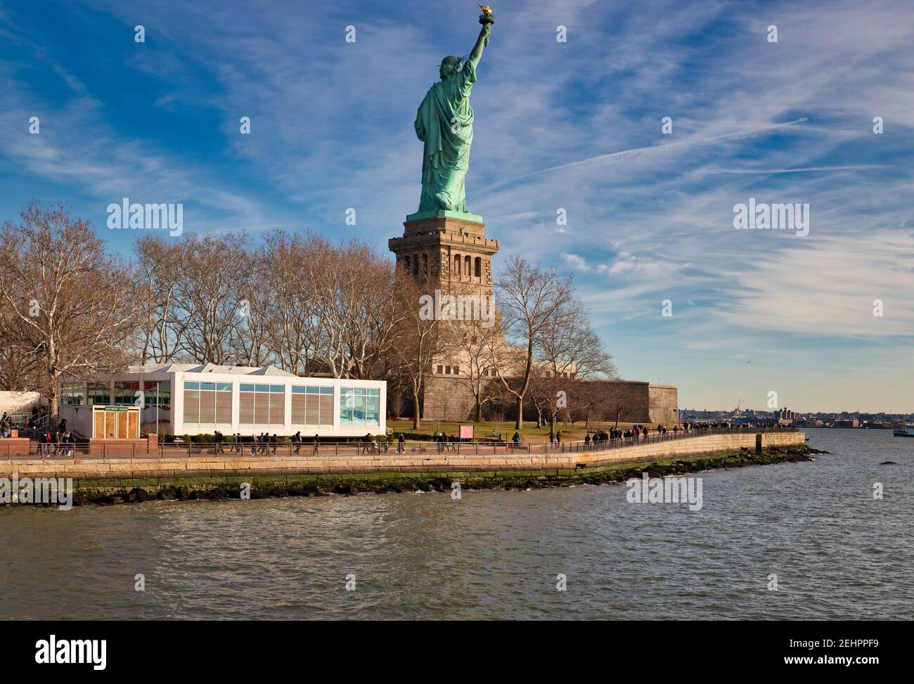 The Statue of Liberty in New York City USA daylight  view  from the back  in Liberty Island with clouds in the  sky  in background Stock Photo