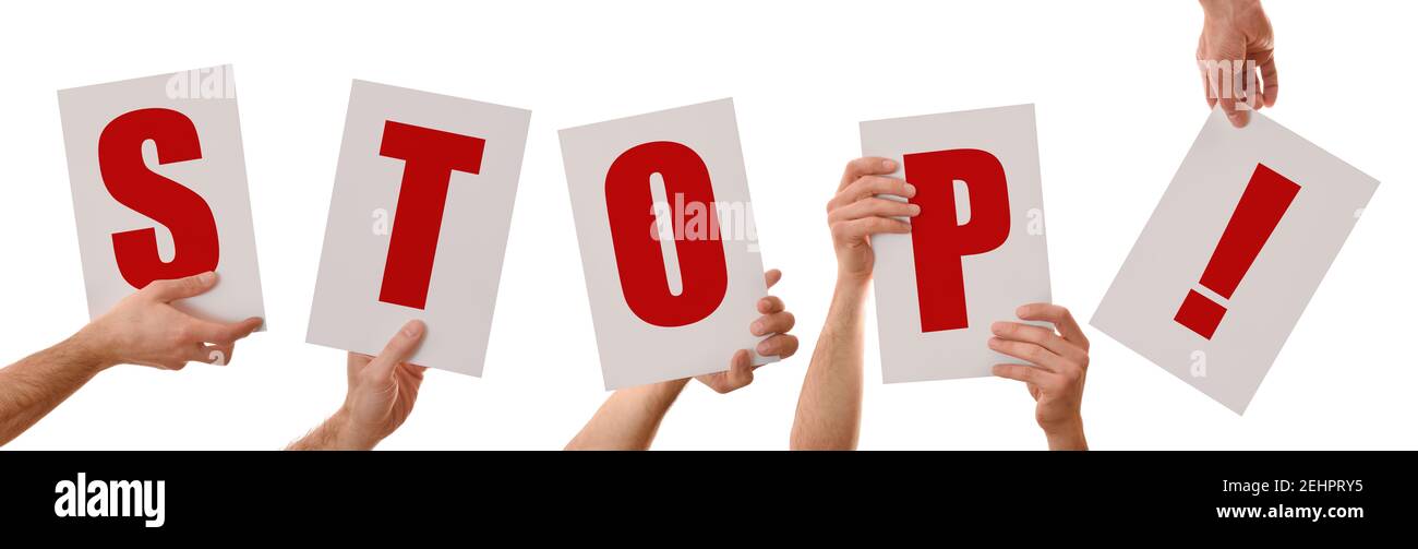 Hands showing placard with letters with the word stop isolated background Stock Photo