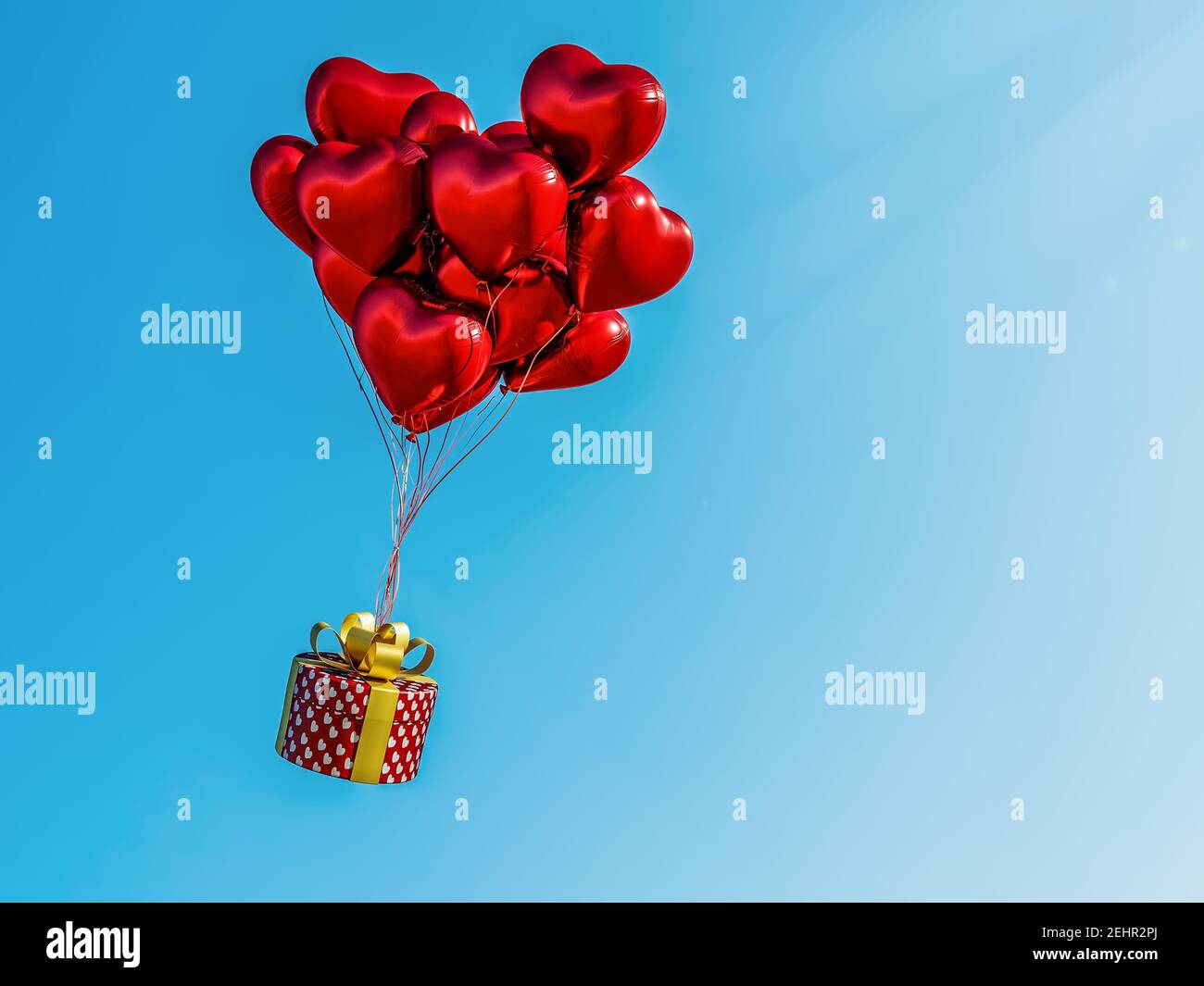 3D rendering of bunch of red heart-shaped balloons carrying gift box over the clear blue sky Stock Photo