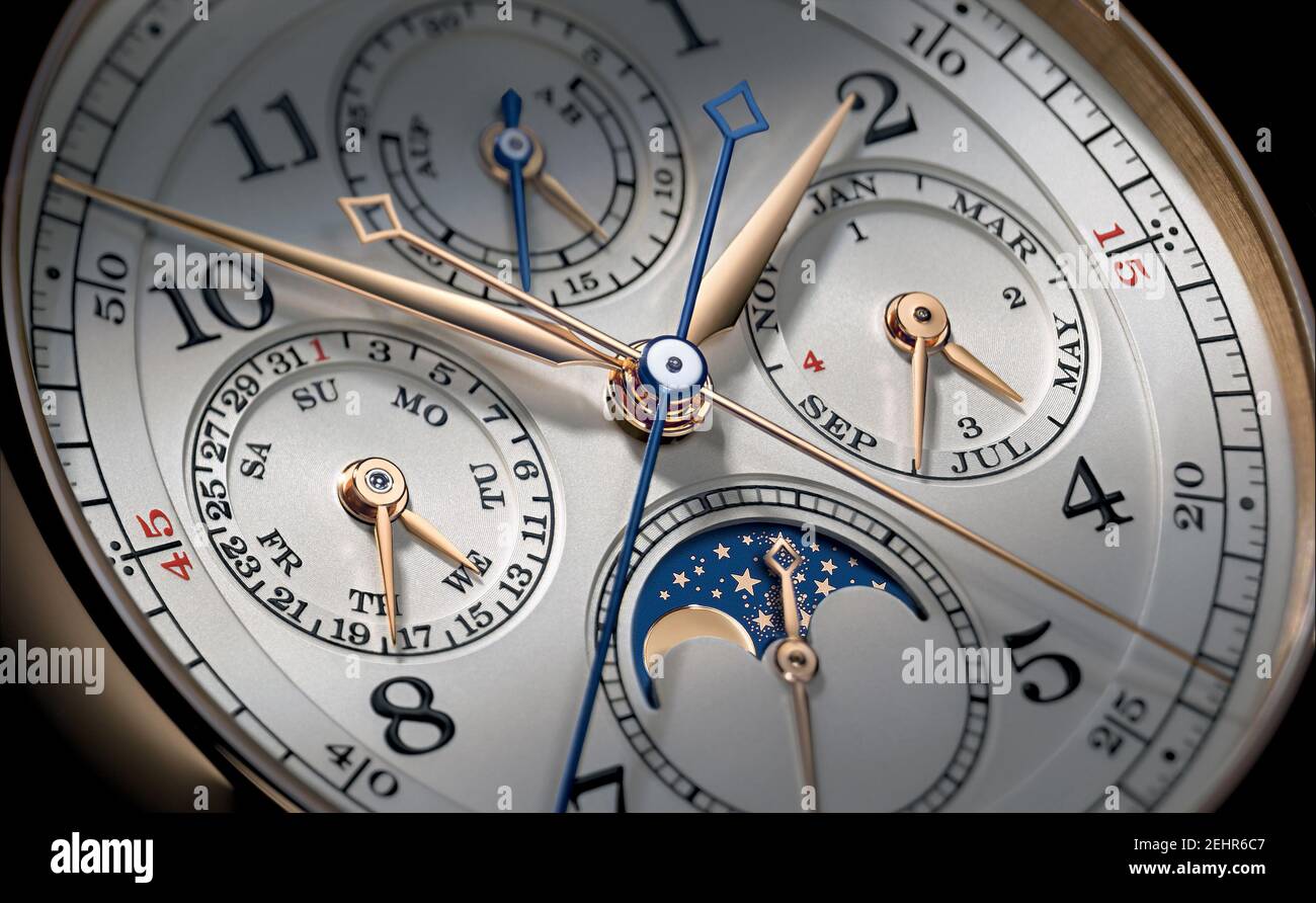 Detail of a men's sports wristwatch with moon phase and stopwatch. Round titanium dial. Stock Photo