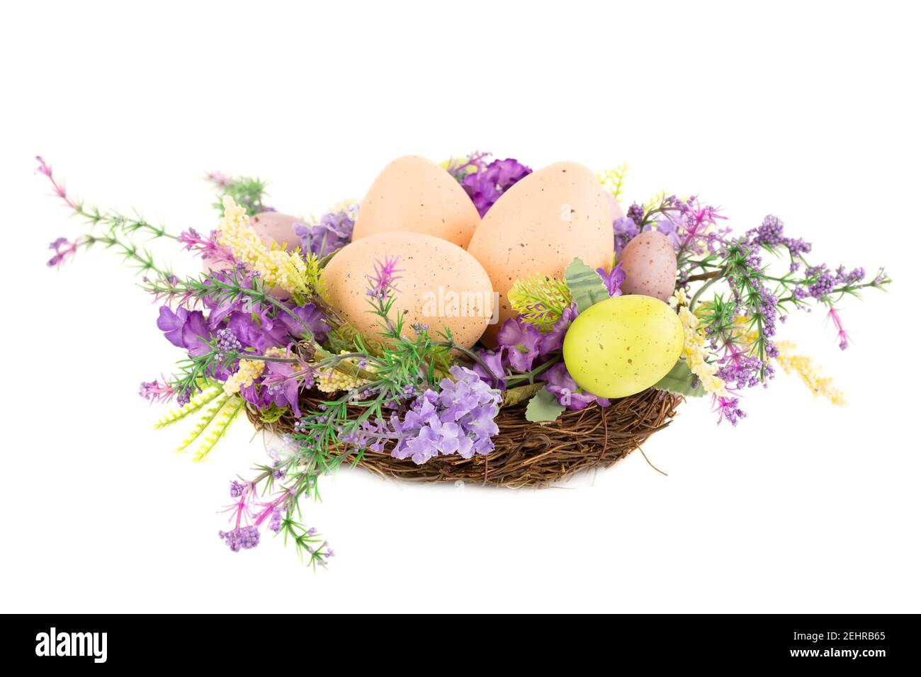 Easter colorful eggs in nest and flowers isolated on white background ...