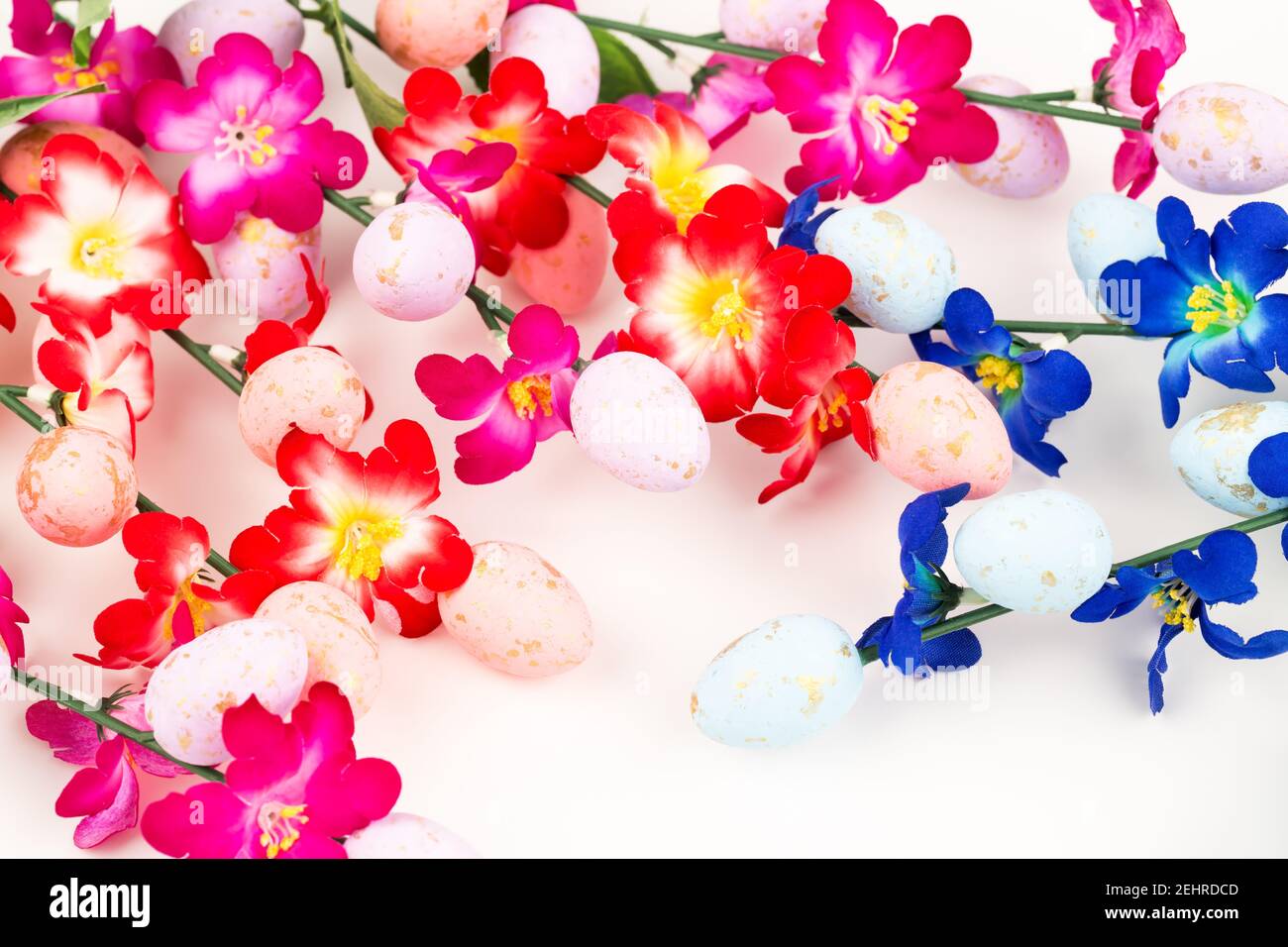 Easter colorful eggs and flowers on white background Stock Photo - Alamy