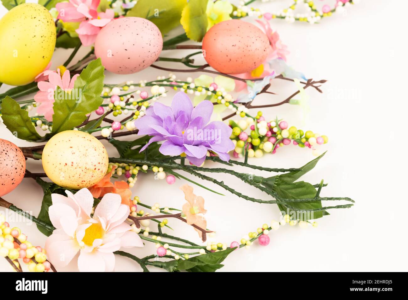 Easter colorful eggs and flowers on white background Stock Photo - Alamy