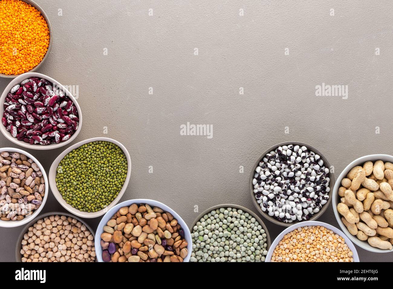 Different types of legumes in bowls, green and yellow peas, chickpeas