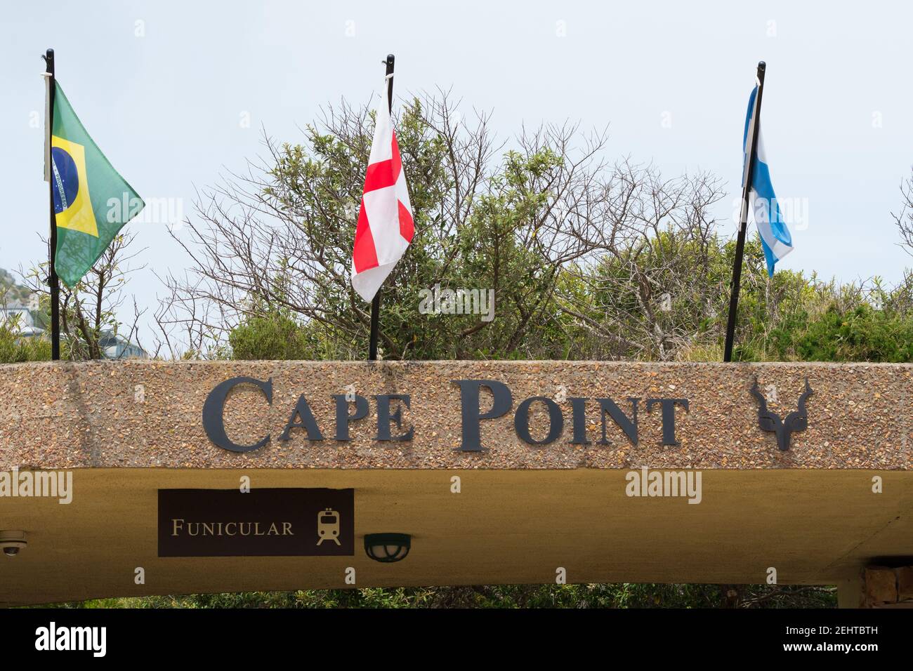 Cape Point nature reserve name at the funicular terminal with international country flags above concept travel destination in South Africa Stock Photo