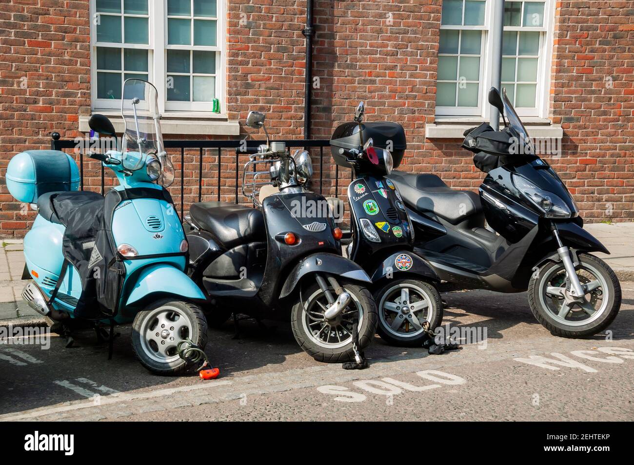 London, UK, March 21, 2009 : Vespa moped and scooters along with a motorbike parked in a solo parking bay in the city centre, stock photo image Stock Photo