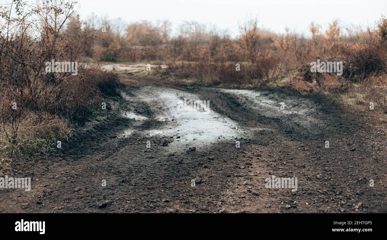 Dark rural dirt road with mud texture background Stock Photo