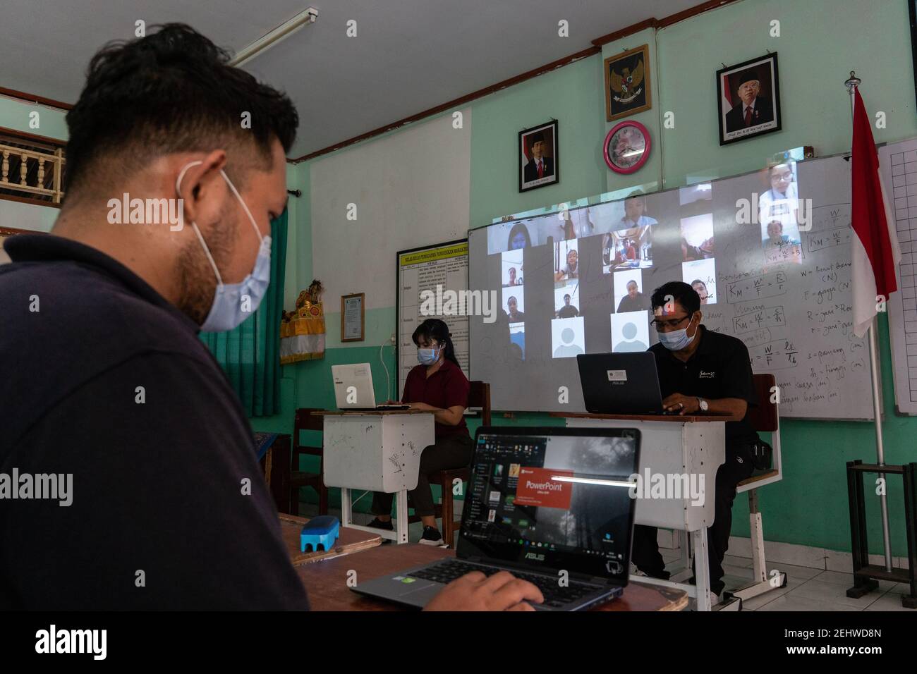 BALI/INDONESIA-NOV 6 2020: teachers in Indonesia are sitting in front of a laptop carrying out the process of teaching online to their students during Stock Photo