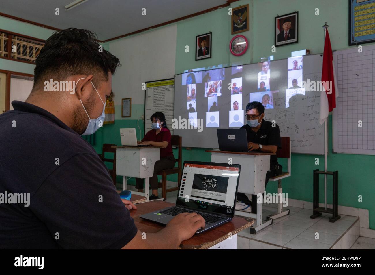 BALI/INDONESIA-NOV 6 2020: teachers in Indonesia are sitting in front of a laptop carrying out the process of teaching online to their students during Stock Photo