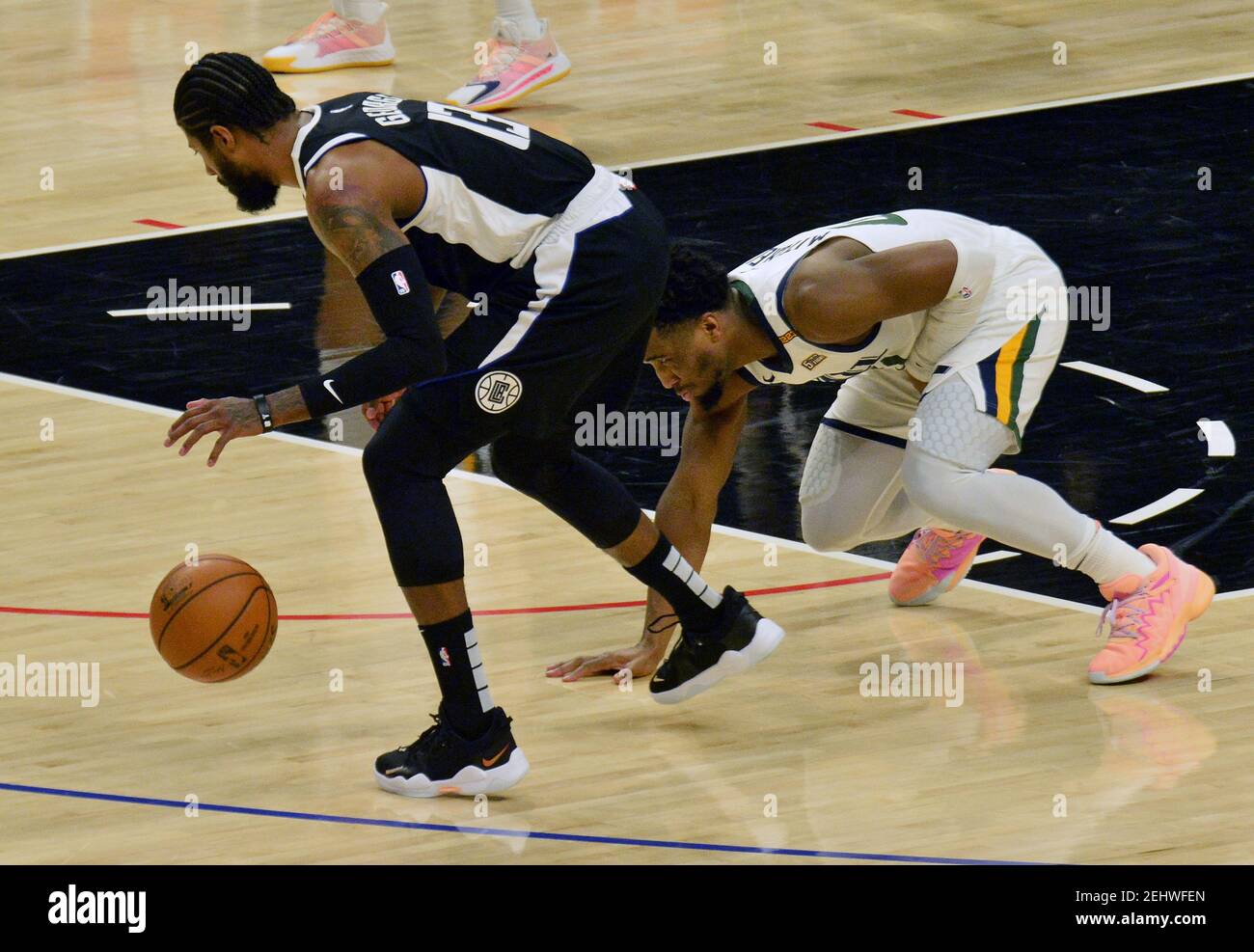 Los Angeles Clippers' guard Paul George chases the loose ball after the attempted steal by Utah Jazz guard Donovan Mitchell during the first half at Staples Center in Los Angeles on Friday, February 19, 2021. The Clippers defeated the Jazz 116-112.  Photo by Jim Ruymen/UPI Stock Photo