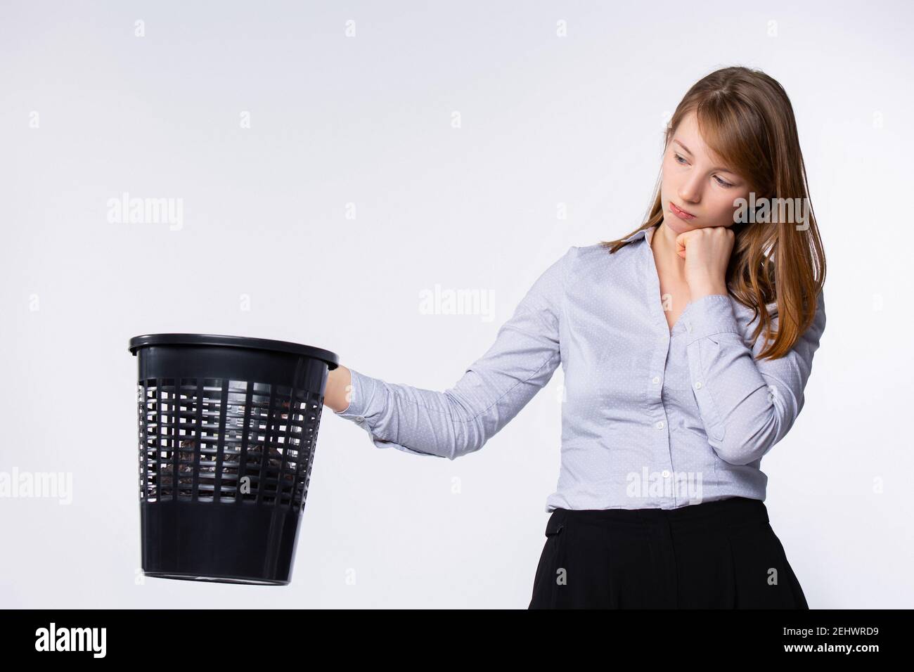 Sad volunteer picking garbage. Woman with trash bin, dreams about
