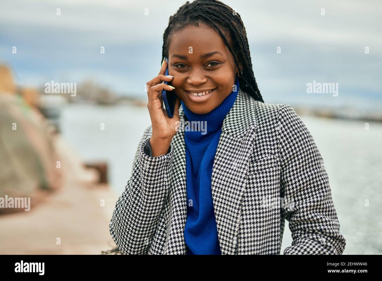Young african american businesswoman smiling happy talking on the smartphone at the port. Stock Photo