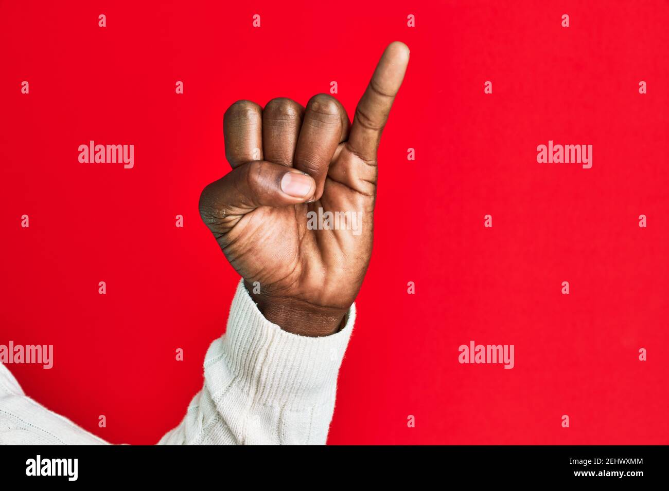 Arm and hand of african american black young man over red isolated