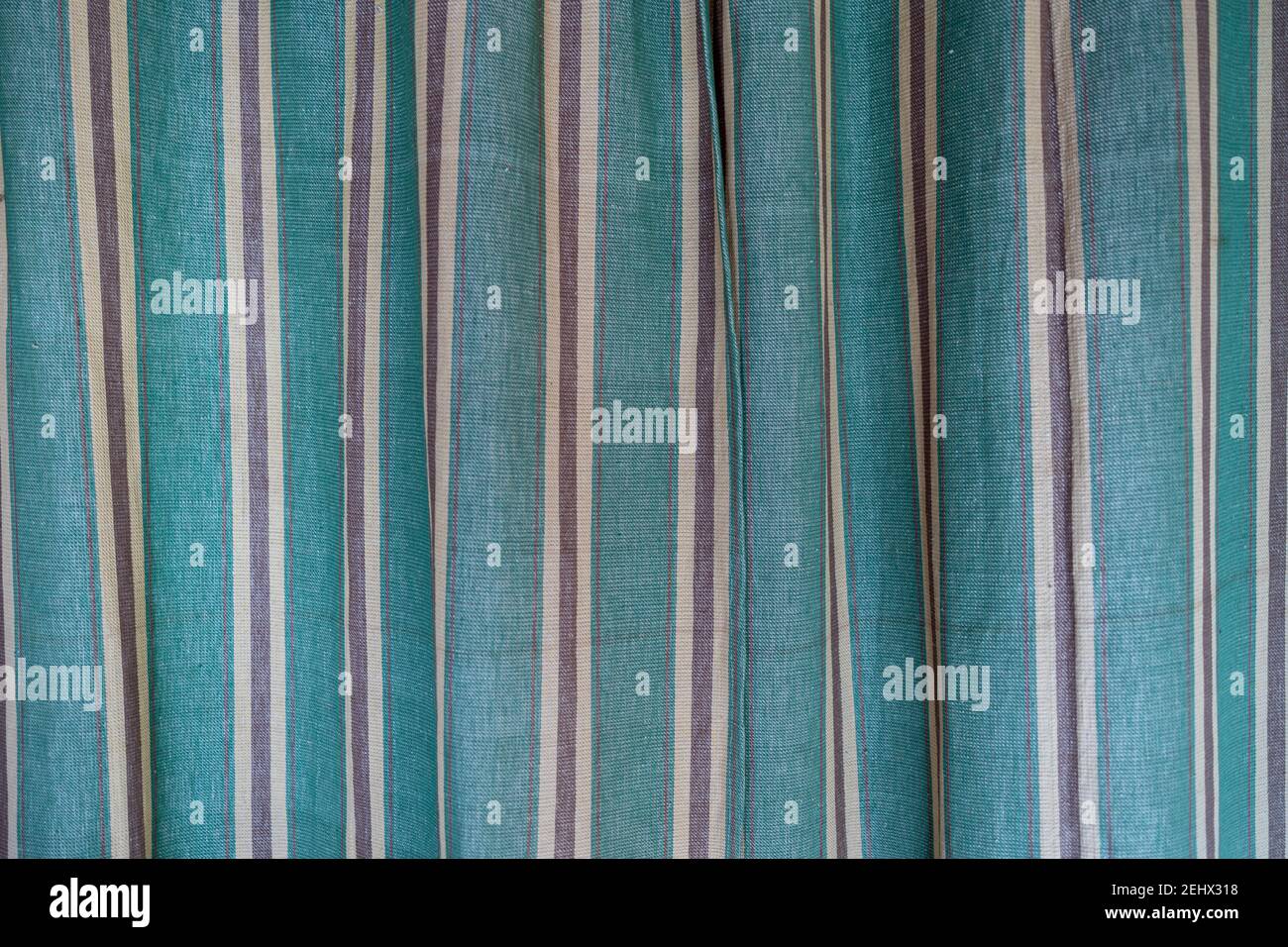 vintage green brown and white vertical striped fabric curtain Stock Photo