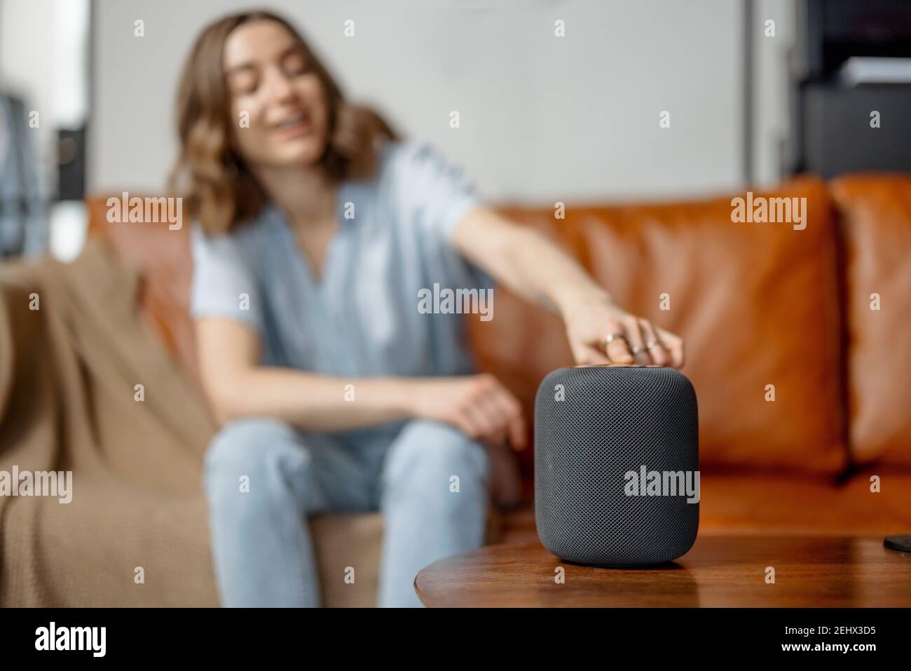 Woman speaking with audio assistant column  Stock Photo