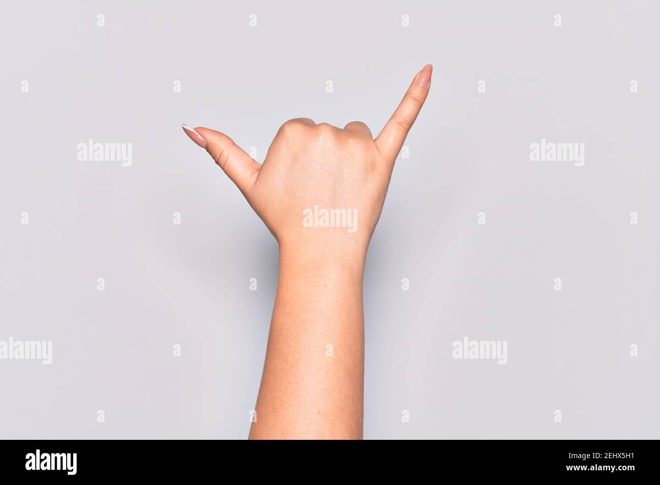 Hand of caucasian young woman gesturing Hawaiian shaka greeting gesture, telephone and communication symbol Stock Photo