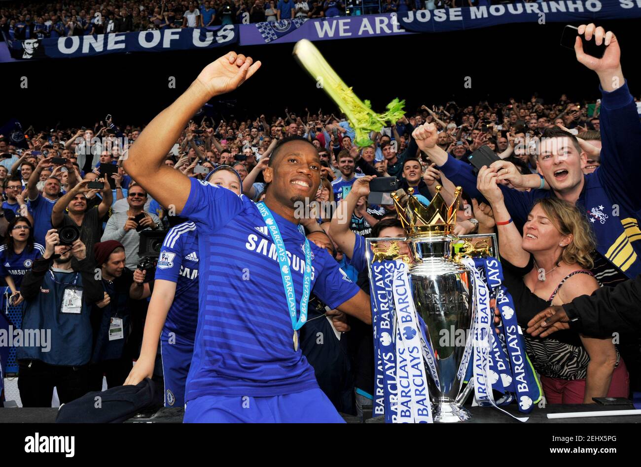 Football - Chelsea v Sunderland - Barclays Premier League - Stamford Bridge - 24/5/15 Chelsea's Didier Drogba celebrates with the trophy as celery is thrown after winning the Barclays Premier League Action Images via Reuters / Adam Holt Livepic EDITORIAL USE ONLY. No use with unauthorized audio, video, data, fixture lists, club/league logos or 'live' services. Online in-match use limited to 45 images, no video emulation. No use in betting, games or single club/league/player publications.  Please contact your account representative for further details. Stock Photo