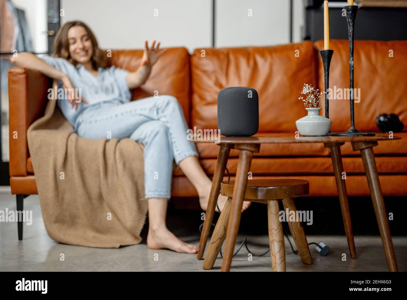Woman speaking with audio assistant column  Stock Photo