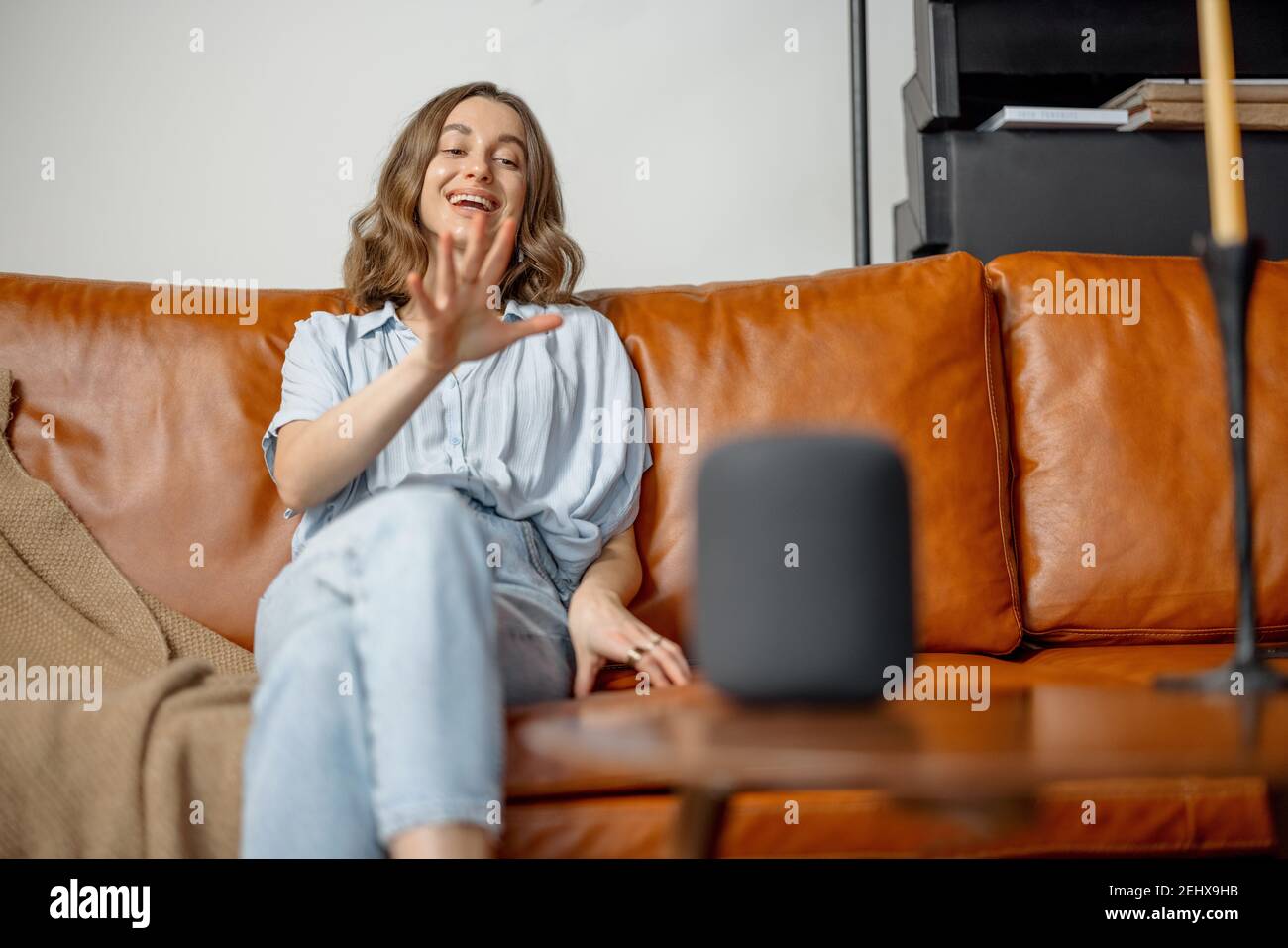 Woman speaking with audio assistant column  Stock Photo