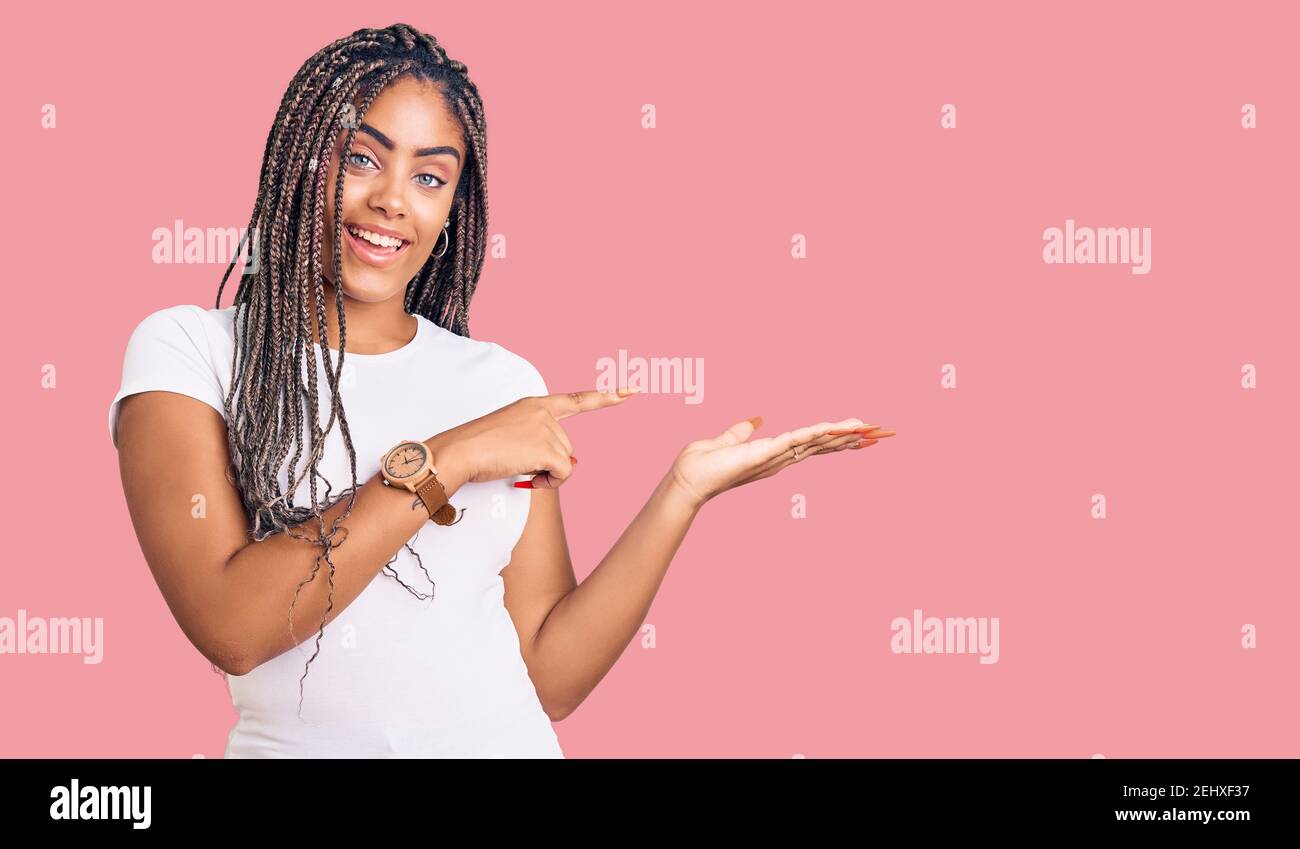Young african american woman with braids wearing casual clothes amazed ...