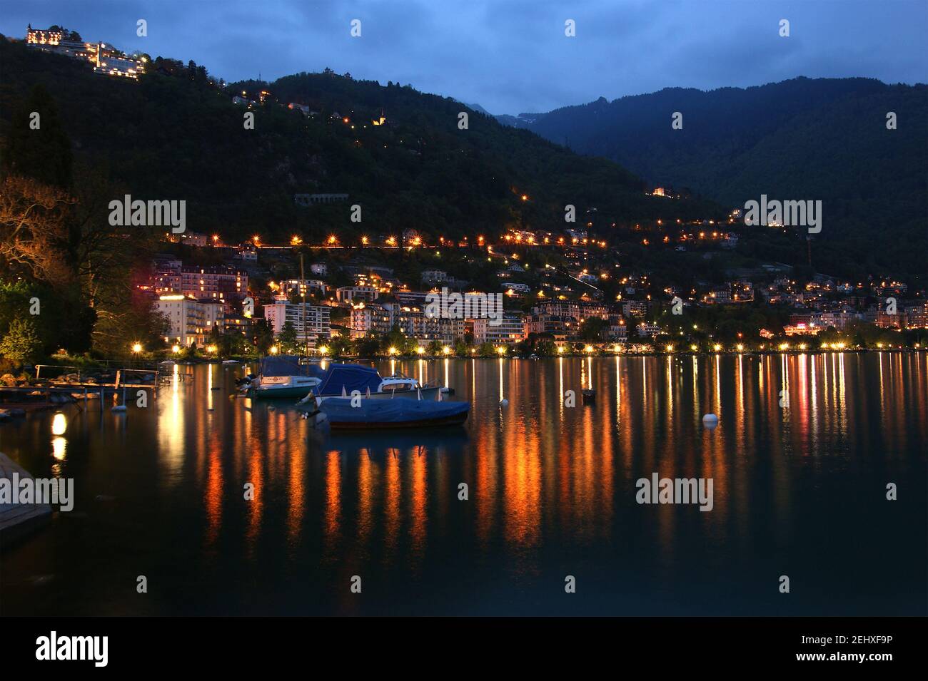 Switzerland, Montreux, a night view of Lake Geneva and the Alps Stock ...