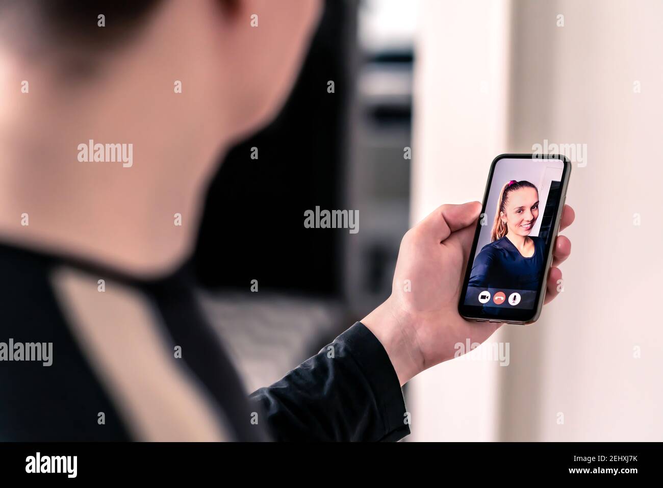 Video call with mobile phone. Man and woman talking in online cam chat and virtual meeting conference on internet. Smiling face of a friend. Stock Photo