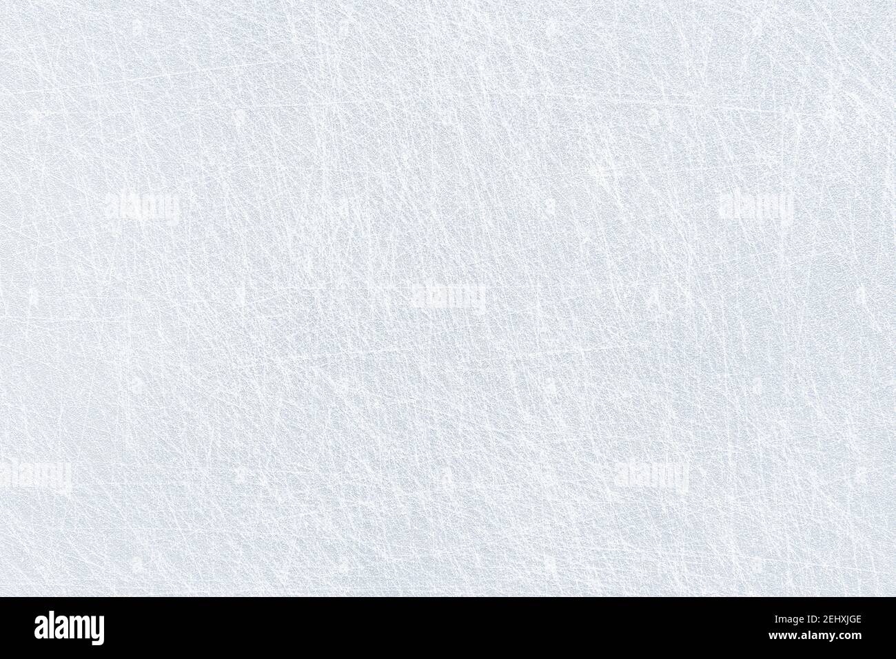 Ice background texture and snow surface with marks and lines from skating. Ice hockey rink, arena or stadium from top view. Light blue frost wallpaper. Stock Photo