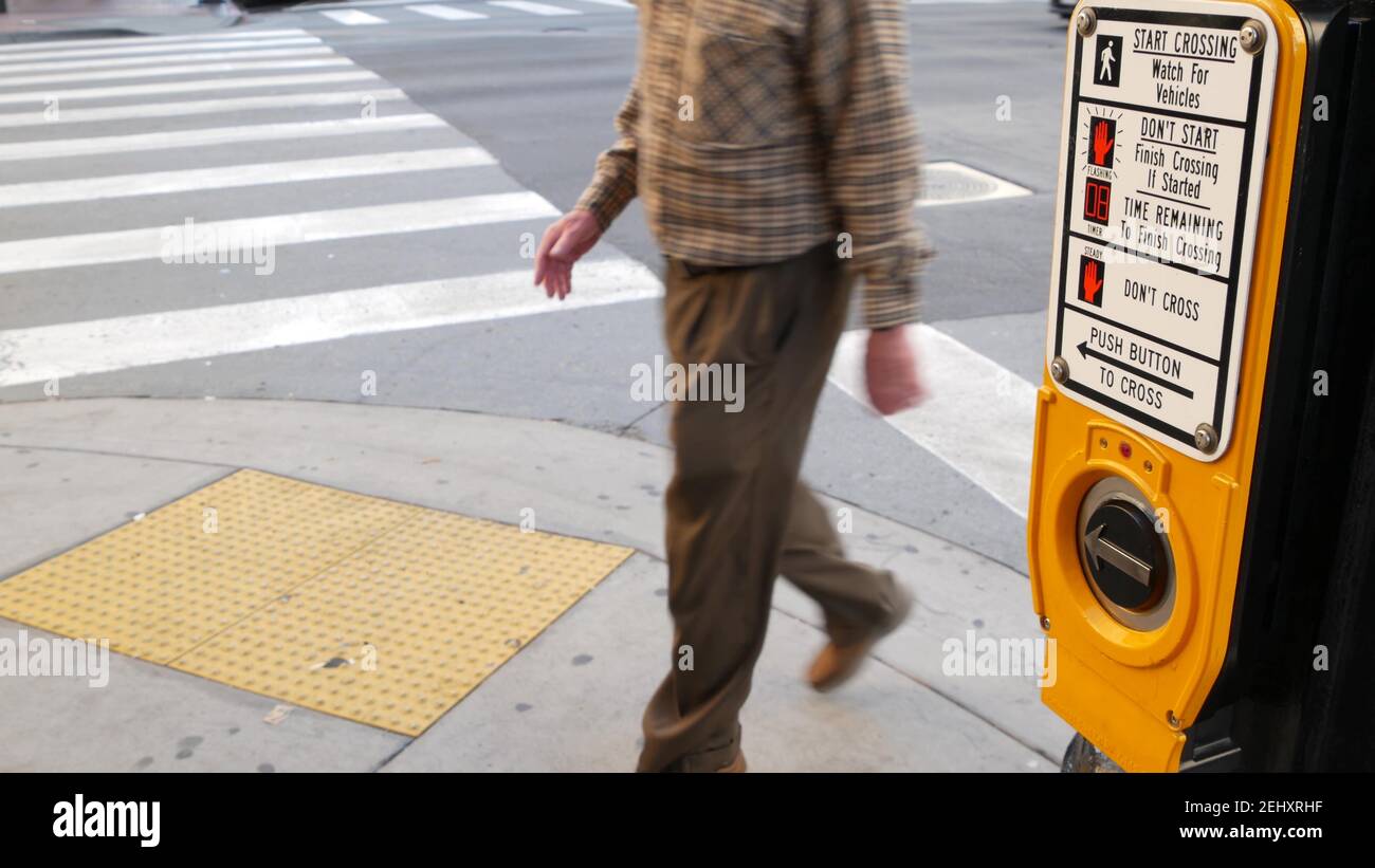 Traffic light button on pedestrian crosswalk, people have to push and