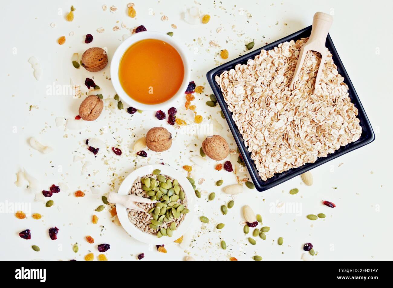 Concept of bowls full of seeds, cereals and honey on white background, top table Stock Photo Alamy