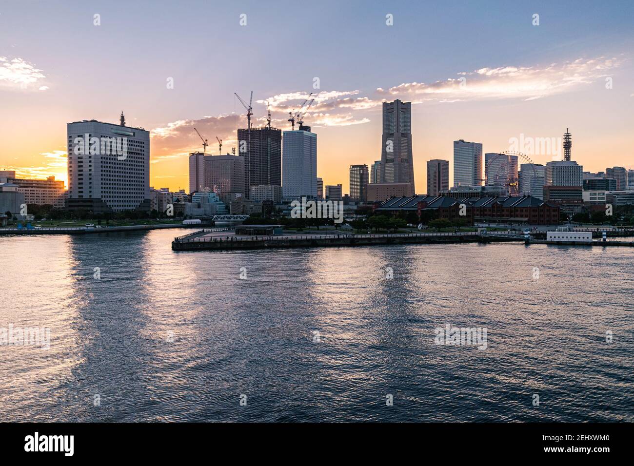 Colorful sunset over the buildings at the Yokohama Ferry Terminal. Stock Photo