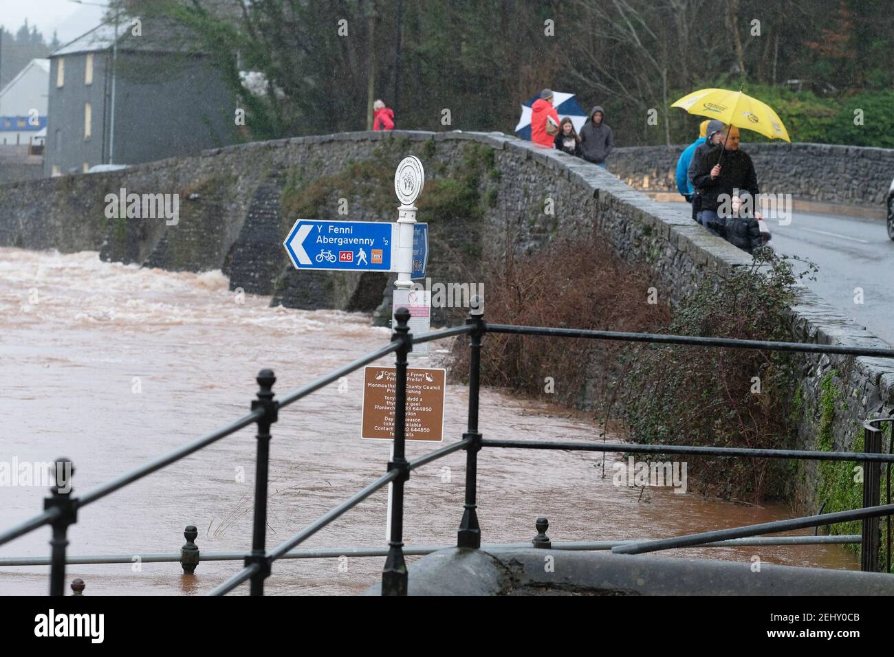 Abergavenny, Monmouthshire, Wales, UK - UK Weather - Saturday 20th February 2021 - The River Usk in fast flow has started to overflow its banks after heavy rain over the past 24 hours in south Wales. The forecast is for more rain. Photo Steven May / Alamy Live News Stock Photo