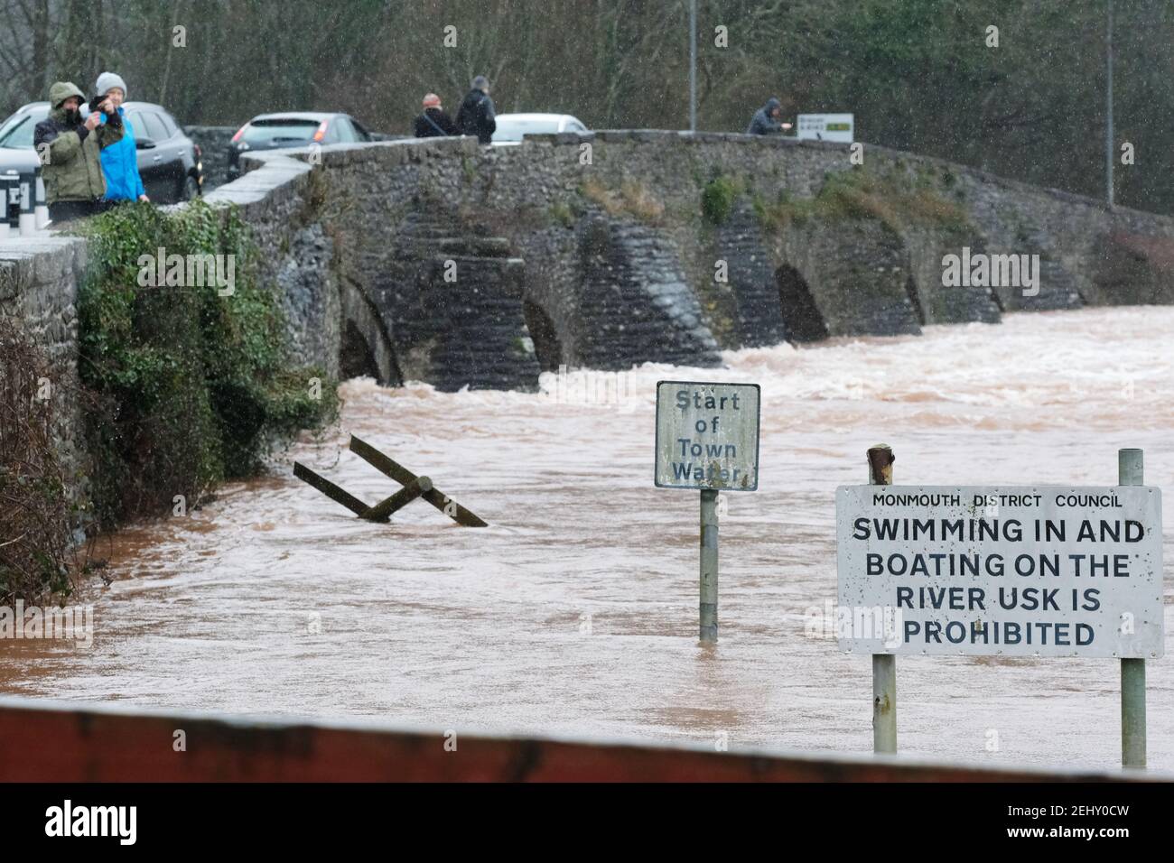 Abergavenny, Monmouthshire, Wales, UK - UK Weather - Saturday 20th February 2021 - The River Usk in fast flow has started to overflow its banks after heavy rain over the past 24 hours in south Wales. The forecast is for more rain. Photo Steven May / Alamy Live News Stock Photo